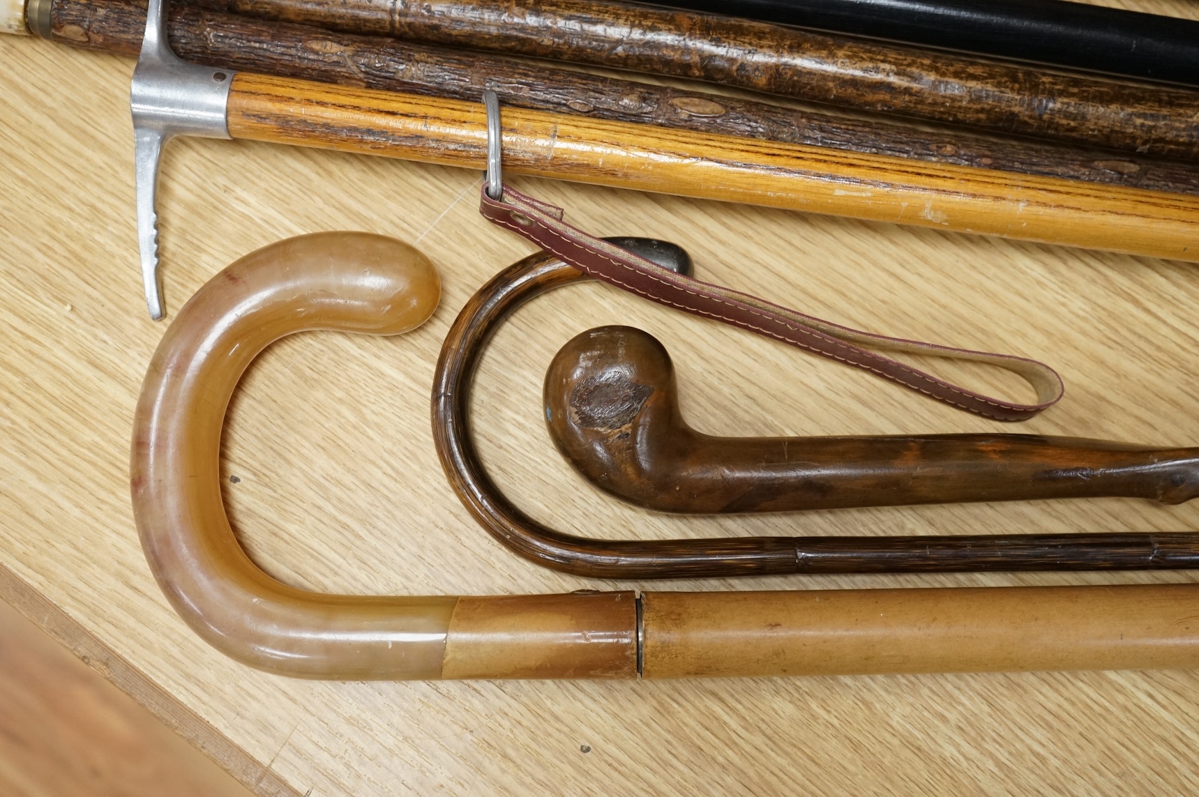 A collection of various walking sticks, one silver mounted